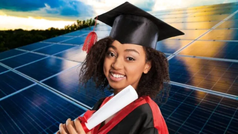 A smiling graduate in a cap and gown holds a diploma, with a large field of solar panels and a bright sky in the background, representing scholarships for African students