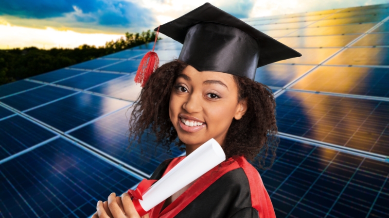 A smiling graduate in a cap and gown holds a diploma, with a large field of solar panels and a bright sky in the background, representing scholarships for African students