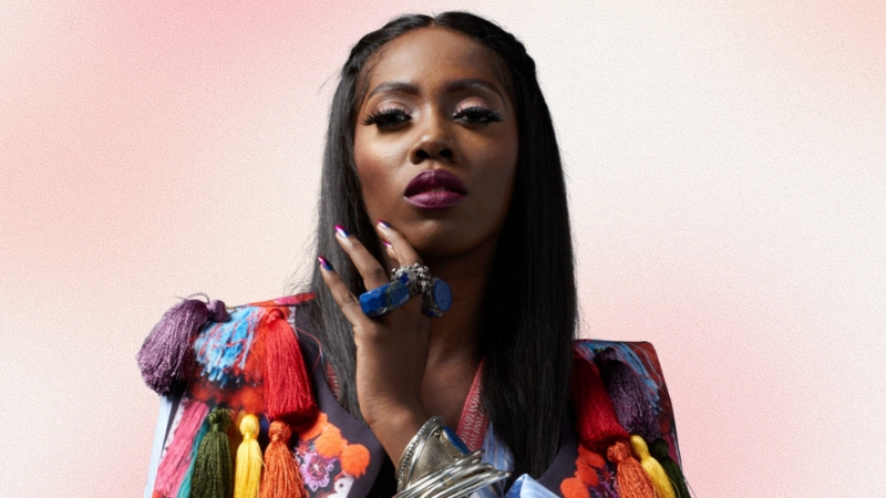 Tiwa Savage poses in bold colors and statement jewelry, reflecting her influence in the African beauty industry