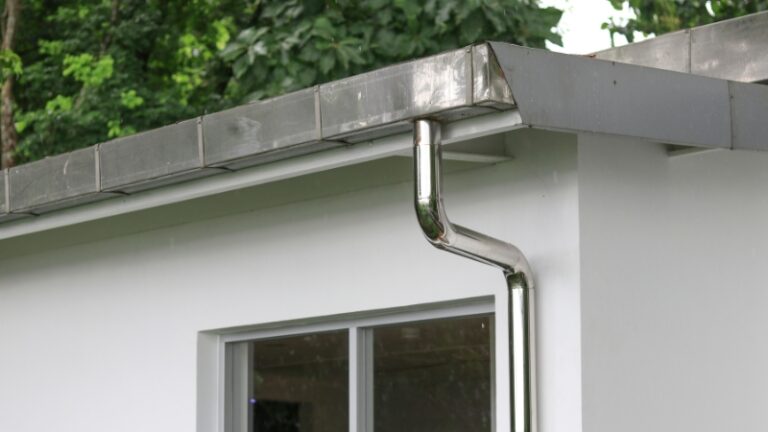 Roof drainage system connected to a modern house wall designed for efficient roof drainage and rainwater storage
