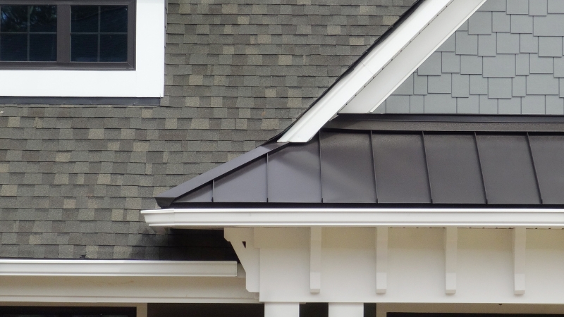 Modern house roof with durable shingles and metal gutter system