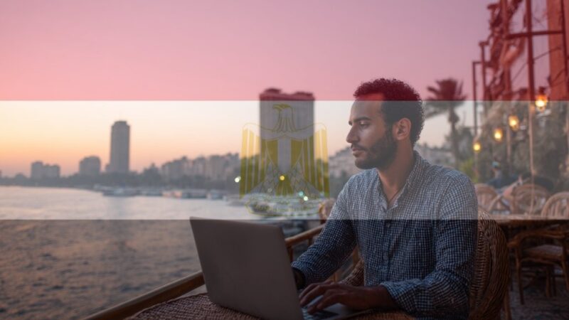 Egyptian freelancer working with Cairo skyline in background