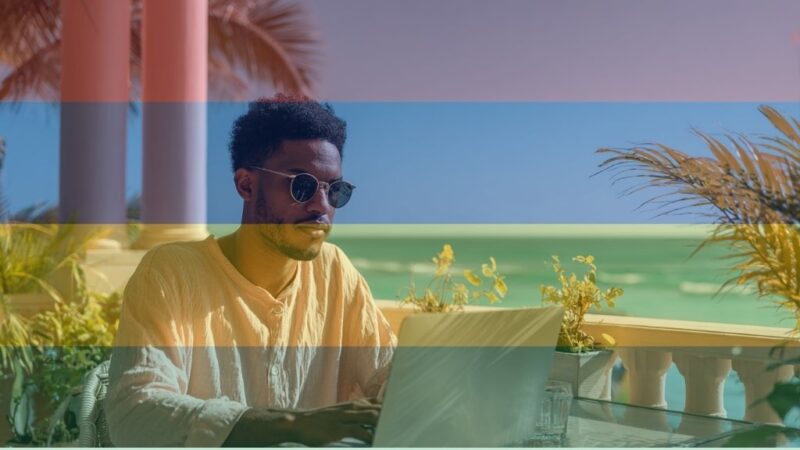 Freelancer in Mauritius working on laptop with ocean in background