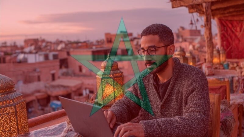 Moroccan freelancer in coworking hub with city rooftop view