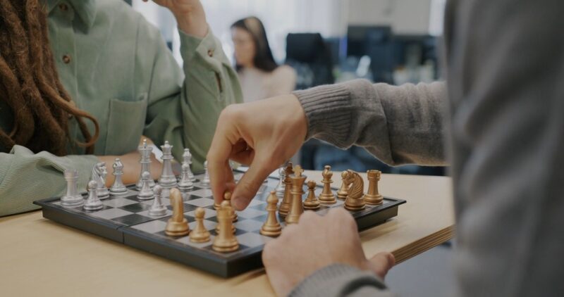 Two people playing chess, representing strategic thinking and niche focus for small businesses