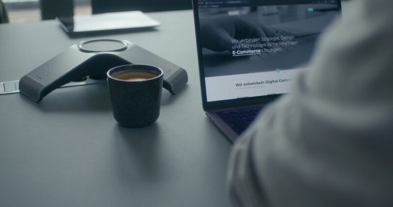 Professional workspace with laptop and coffee cup, symbolizing balanced content and marketing channel strategy